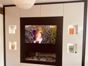 Modern small living room with space saving media wall fireplace design